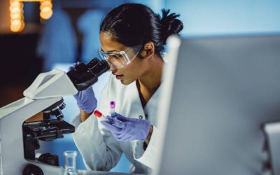Young Scientist Looking Through a Microscope